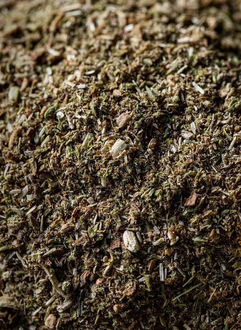A detailed close-up view of a pile of dried Himalayan herb or Tibetan Kangba grass, highlighting their rich textures and earthy tones.