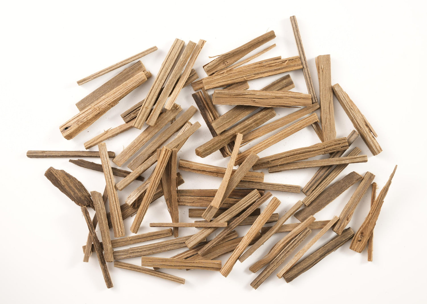 Close-up of natural agarwood chips, a prized aromatic wood often used in resin-based incense blends for its rich, deep fragrance.