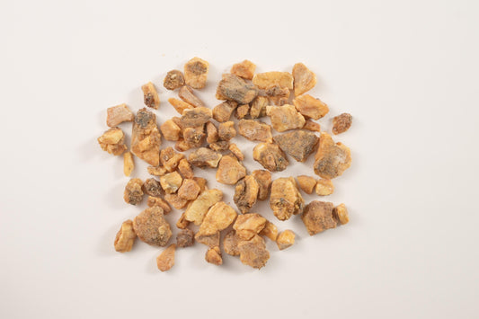 Close-up of raw benzoin resin chunks, a key ingredient in traditional resin-based incense blends.