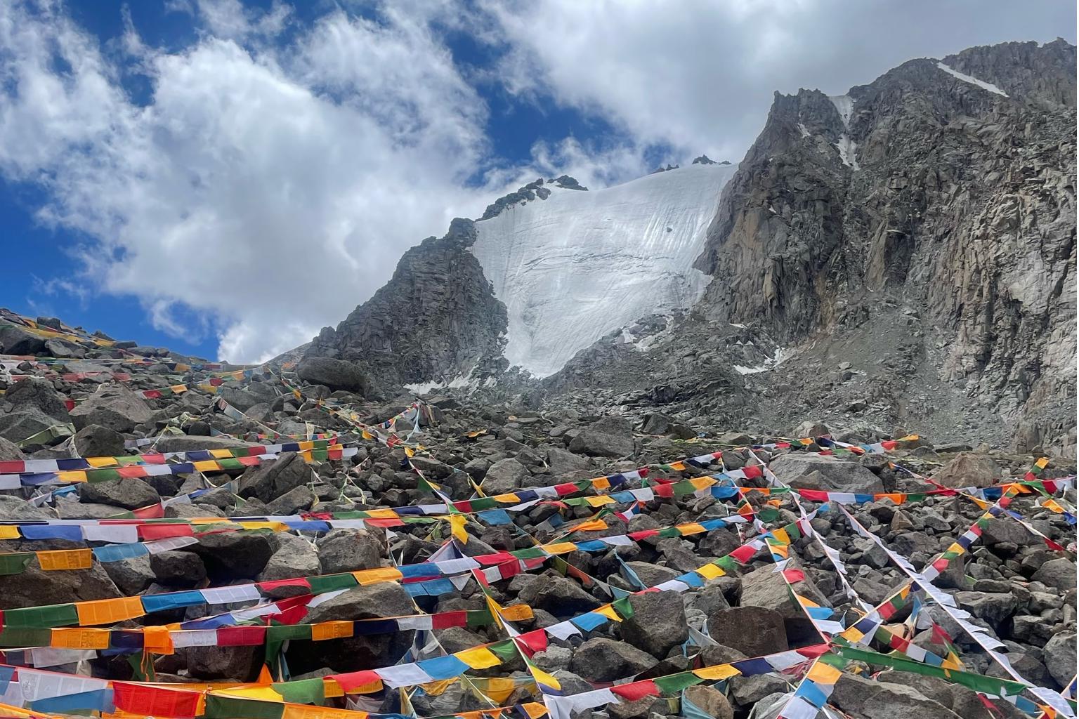 A picturesque view of a mountain in Tibet adorned with colorful prayer flags fluttering in the wind.