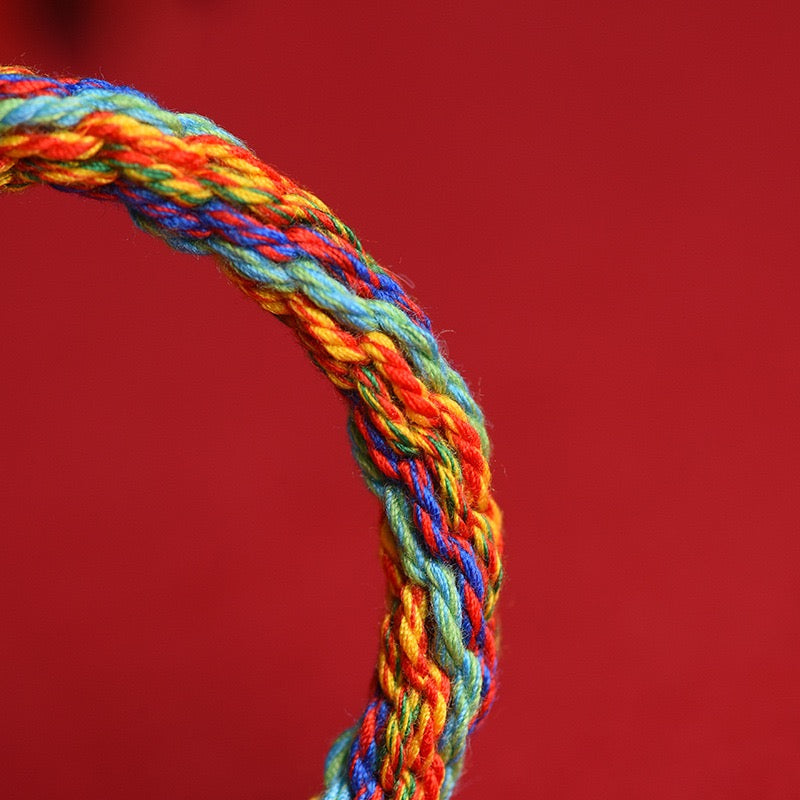 Detailed view of the five-color hand-braided eight-strand cotton cord symbolizing balance, harmony, and protection.