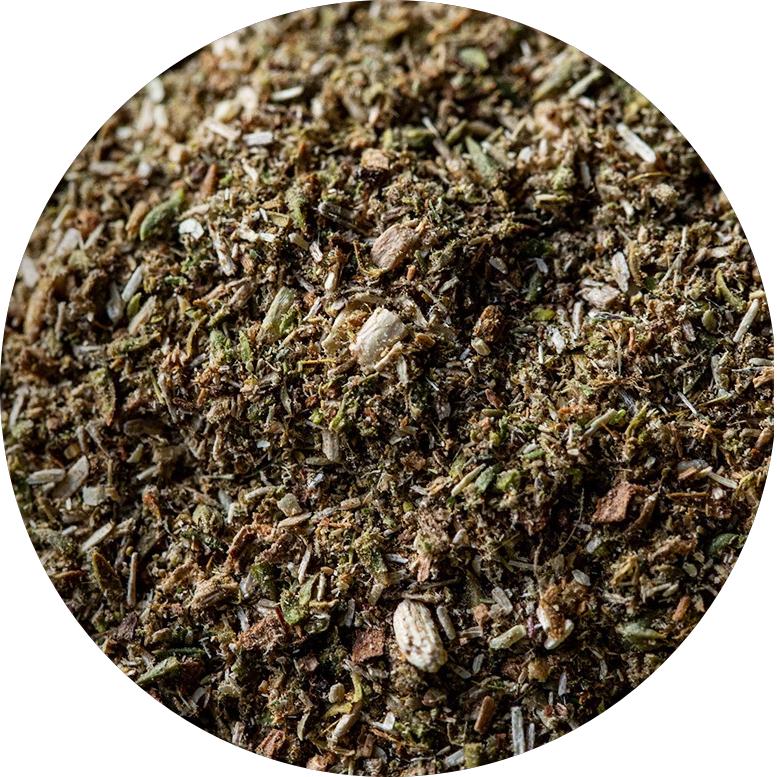 A detailed close-up view of a pile of dried Himalayan herb or Tibetan Kangba grass, highlighting their rich textures and earthy tones.