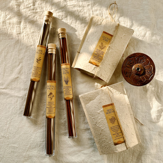 Lhasa Remedy’s All-in-One Box featuring five signature Tibetan incense blends—Nimu Village, Potala Palace, Chomolung Snow, Lucky Zaki, and Sera Serene—styled with a mantra-engraved incense holder on natural linen in golden sunlight.
