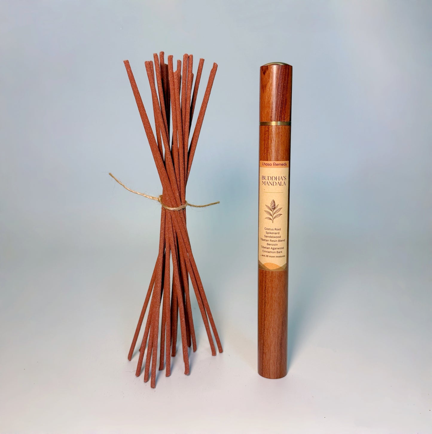 Lhasa Remedy’s Buddha’s Mandala Tibetan incense shown with a bundle of handcrafted incense sticks and the wooden storage tube.