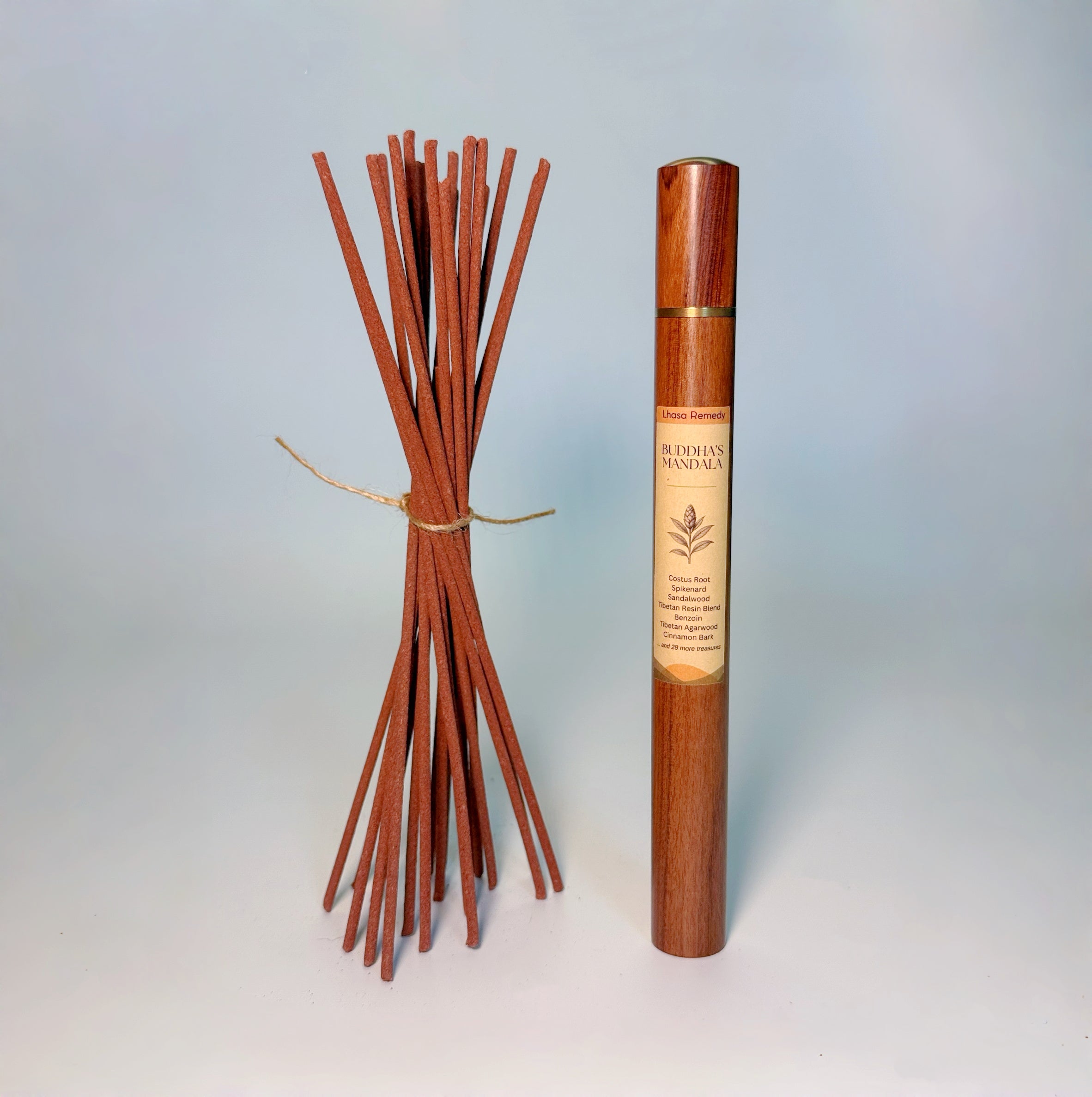 Lhasa Remedy’s Buddha’s Mandala Tibetan incense shown with a bundle of handcrafted incense sticks and the wooden storage tube.